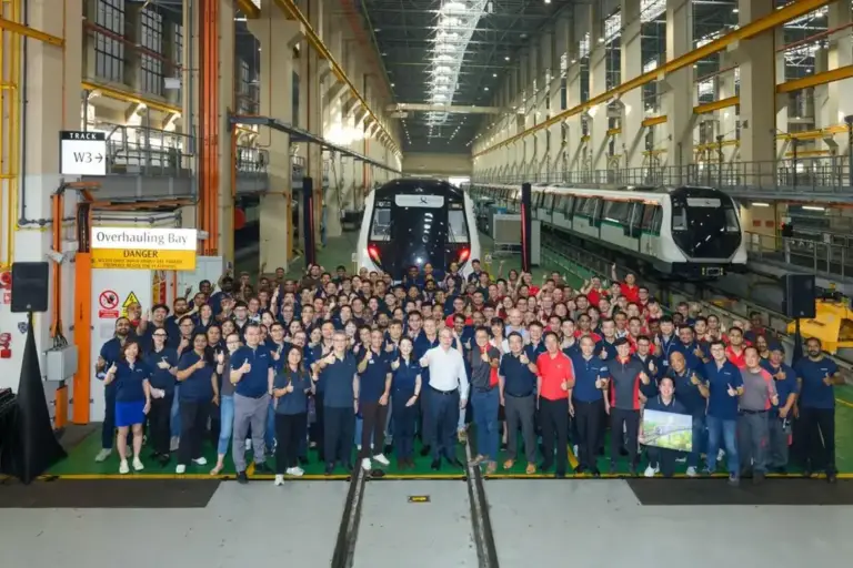 Depot staff group photo celebrating the final R151 train handover in Singapore