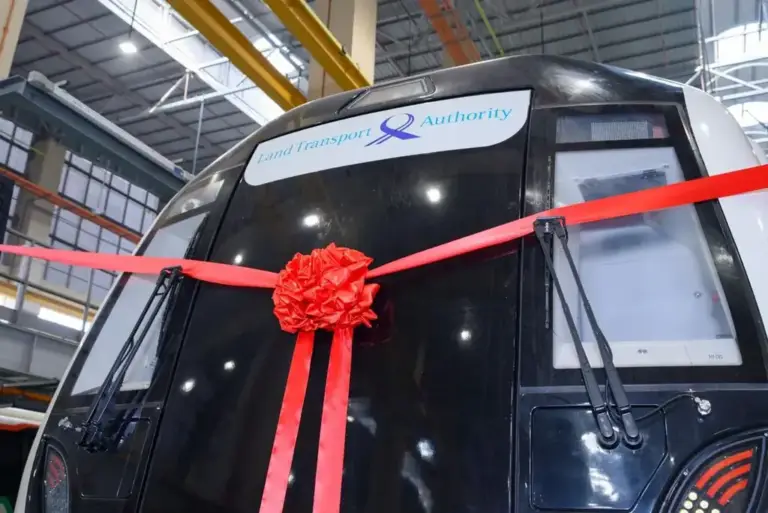 Close-up of a red satin ribbon bow on the front of a new MRT train for a handover ceremony