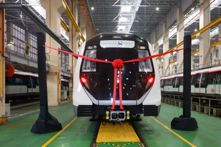 Ribbon cutting setup across the front of a new MRT train at a train depot in Singapore